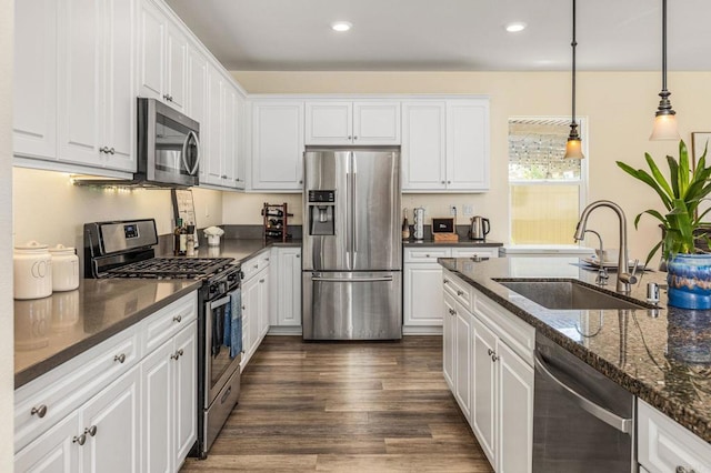 2910 Lucia Jade Loop, San Diego, CA 92139 - kitchen with stainless steel appliances, white cabinets, dark wood-type flooring, dark stone counters, and recessed lighting