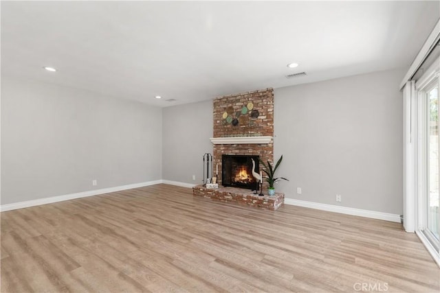 1837 N Studebaker Rd, Long Beach, CA 90815 - unfurnished living room with light wood-style floors, a brick fireplace, and recessed lighting