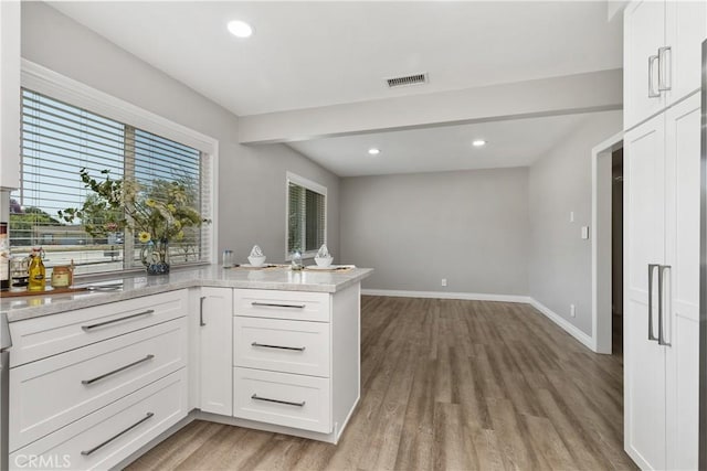 1837 N Studebaker Rd, Long Beach, CA 90815 - kitchen with light wood finished floors, white cabinets, recessed lighting, and a peninsula