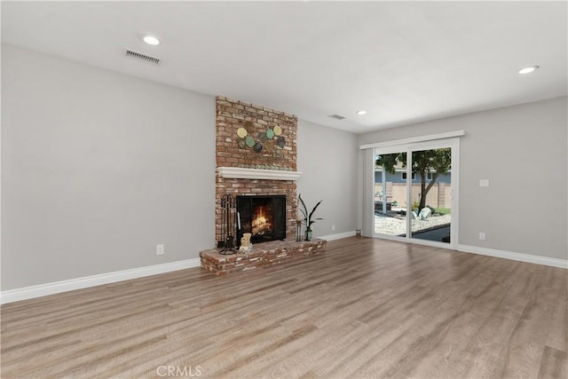 1837 N Studebaker Rd, Long Beach, CA 90815 - unfurnished living room with wood finished floors, a fireplace, and recessed lighting