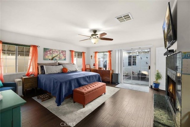 1320 Carob Way, Montebello, CA 90640 - bedroom featuring a tiled fireplace, hardwood / wood-style floors, ceiling fan, and access to outside