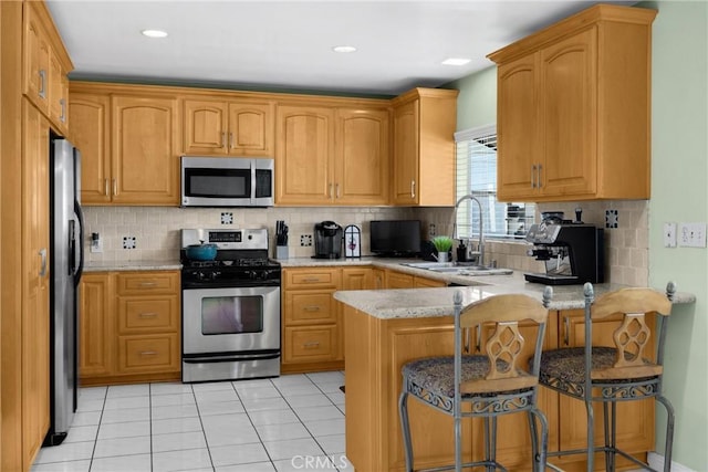 1320 Carob Way, Montebello, CA 90640 - kitchen featuring stainless steel appliances, a peninsula, tasteful backsplash, a breakfast bar area, and recessed lighting