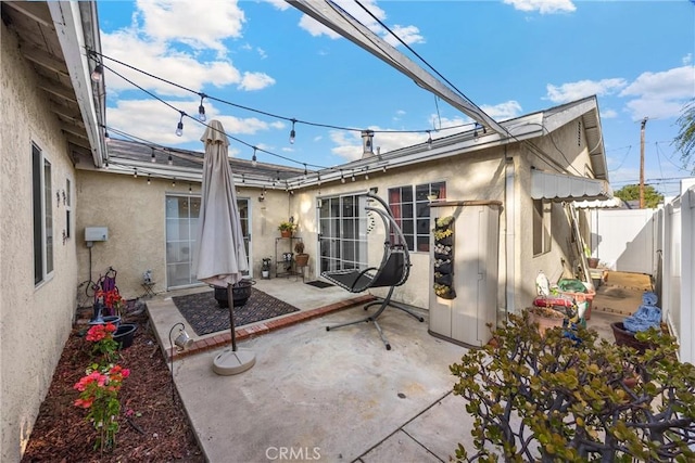 1320 Carob Way, Montebello, CA 90640 - rear view of property featuring stucco siding, a patio, and a fenced backyard