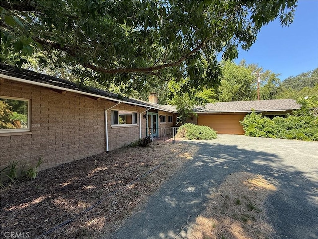 11955 Santa Lucia Rd, Atascadero, CA 93422 - view of side of property with an attached garage, a chimney, and concrete driveway