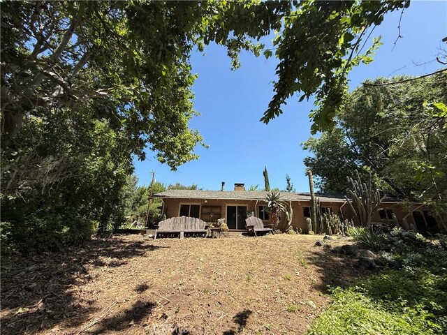 11955 Santa Lucia Rd, Atascadero, CA 93422 - back of house featuring a chimney