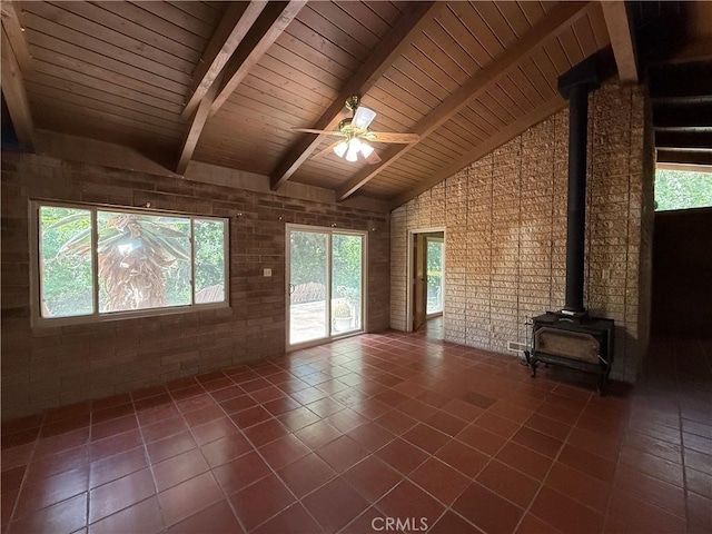 11955 Santa Lucia Rd, Atascadero, CA 93422 - unfurnished living room featuring a wood stove, high vaulted ceiling, tile patterned floors, plenty of natural light, and a ceiling fan
