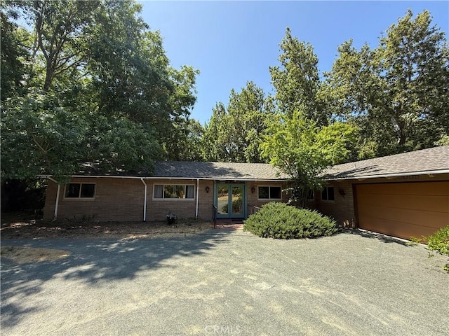 11955 Santa Lucia Rd, Atascadero, CA 93422 - ranch-style home featuring a garage, french doors, and gravel driveway