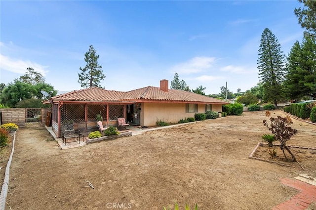 1500 Country Club Dr, Riverside, CA 92506 - back of house featuring a tile roof and a chimney