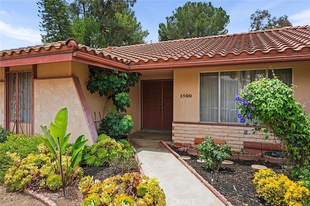 1500 Country Club Dr, Riverside, CA 92506 - entrance to property with stucco siding, a tile roof, and stone siding
