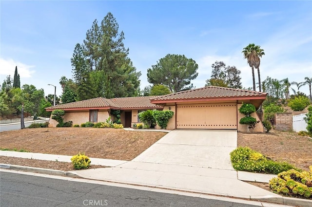 1500 Country Club Dr, Riverside, CA 92506 - ranch-style home featuring an attached garage, a tile roof, stucco siding, and concrete driveway