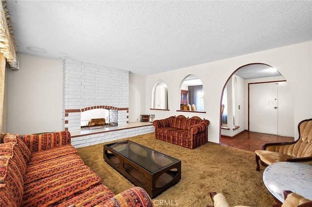 1500 Country Club Dr, Riverside, CA 92506 - living room with a textured ceiling, carpet, and arched walkways