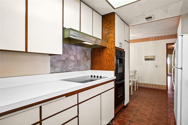 1500 Country Club Dr, Riverside, CA 92506 - kitchen featuring under cabinet range hood, black appliances, light countertops, and white cabinetry
