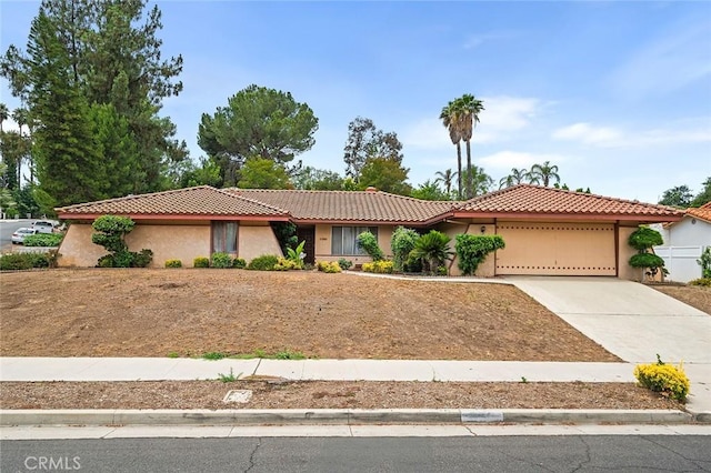 1500 Country Club Dr, Riverside, CA 92506 - view of front of house with an attached garage, a tile roof, stucco siding, and driveway