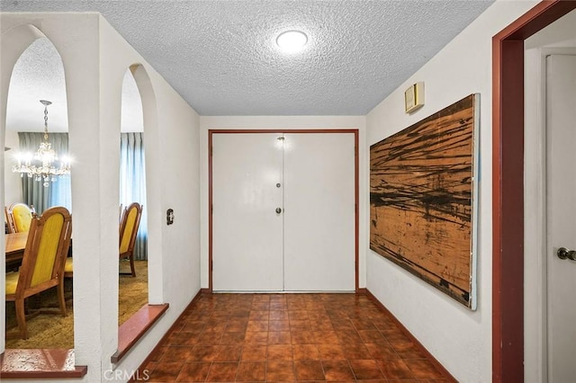1500 Country Club Dr, Riverside, CA 92506 - foyer entrance with a textured ceiling and a chandelier