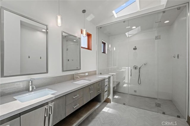 401 8th St, Manhattan Beach, CA 90266 - bathroom featuring a skylight, a shower stall, and double vanity