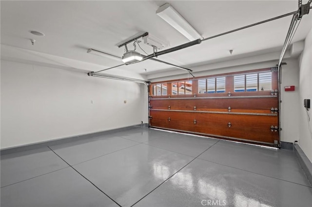 401 8th St, Manhattan Beach, CA 90266 - garage featuring a garage door opener and baseboards