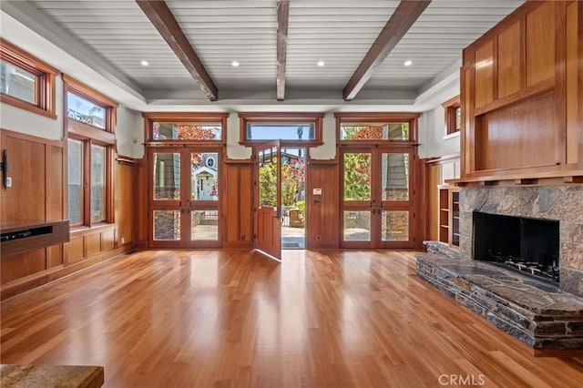 401 8th St, Manhattan Beach, CA 90266 - unfurnished living room with light wood finished floors, beam ceiling, a high end fireplace, wainscoting, and a decorative wall