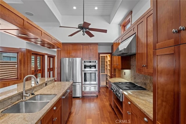 401 8th St, Manhattan Beach, CA 90266 - kitchen with appliances with stainless steel finishes, a warming drawer, under cabinet range hood, wood finished floors, and brown cabinetry