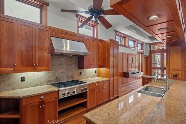 401 8th St, Manhattan Beach, CA 90266 - kitchen featuring wall chimney exhaust hood, brown cabinetry, backsplash, stainless steel gas cooktop, and ceiling fan