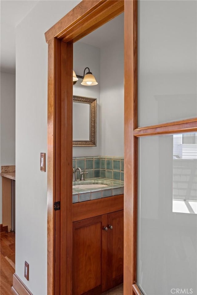 401 8th St, Manhattan Beach, CA 90266 - bathroom featuring vanity, a shower with door, wood finished floors, and backsplash