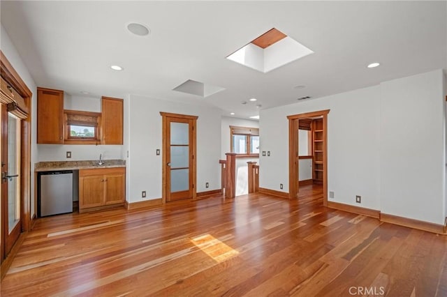 401 8th St, Manhattan Beach, CA 90266 - unfurnished living room featuring light wood-style flooring, a skylight, and recessed lighting