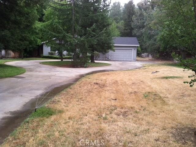 664 Stilson Canyon Rd, Chico, CA 95928 - view of front facade with concrete driveway, an attached garage, and a front yard