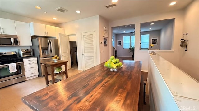 163 Clementine Ct, Covina, CA 91723 - kitchen featuring appliances with stainless steel finishes, recessed lighting, white cabinetry, and wood counters