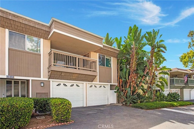23372 Caminito Marcial Unit 187, Laguna Hills, CA 92653 - view of front of home featuring driveway, a garage, a balcony, and stucco siding