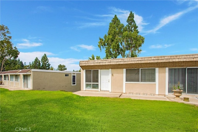 23372 Caminito Marcial Unit 187, Laguna Hills, CA 92653 - rear view of house featuring a yard, stucco siding, and a patio