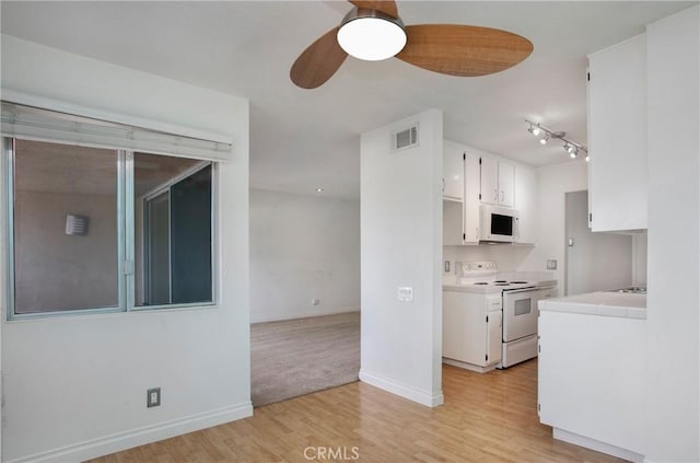 23372 Caminito Marcial Unit 187, Laguna Hills, CA 92653 - kitchen featuring white appliances, white cabinets, light wood finished floors, a ceiling fan, and tile counters