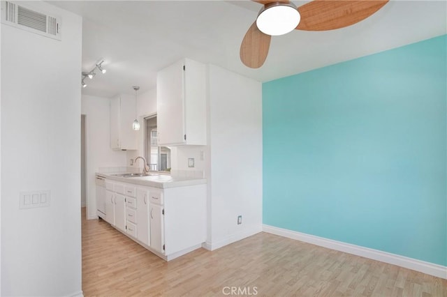23372 Caminito Marcial Unit 187, Laguna Hills, CA 92653 - kitchen featuring light wood-style floors, light countertops, white cabinetry, white dishwasher, and ceiling fan