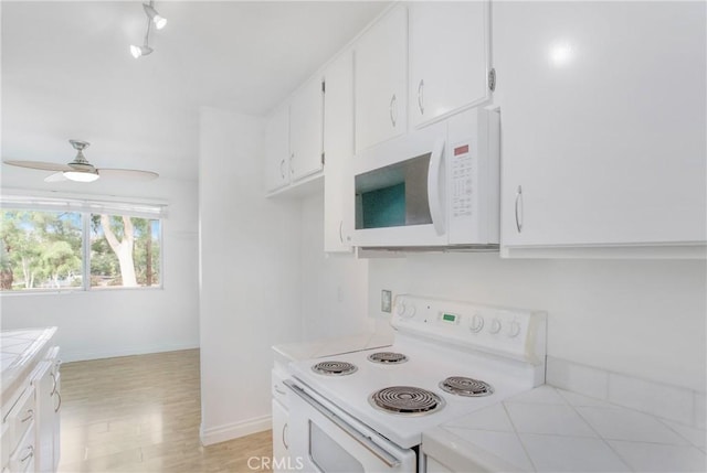 23372 Caminito Marcial Unit 187, Laguna Hills, CA 92653 - kitchen featuring white appliances, tile countertops, white cabinets, a ceiling fan, and light wood-style flooring