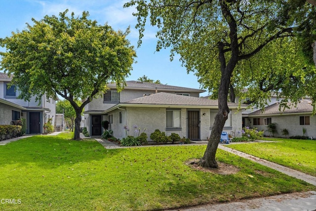 1222 Acadia Pl, Ventura, CA 93003 - view of front of house with stucco siding, a front yard, and stairway
