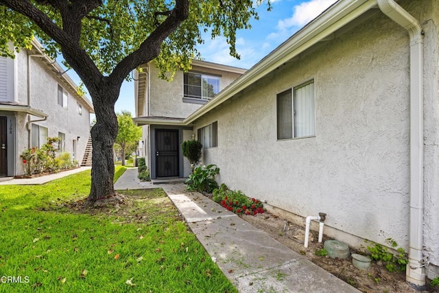 1222 Acadia Pl, Ventura, CA 93003 - property entrance with stucco siding and a lawn