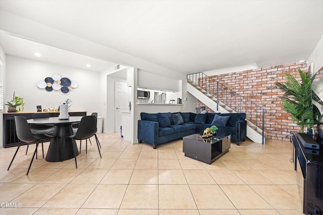 1222 Acadia Pl, Ventura, CA 93003 - living room featuring brick wall, light tile patterned floors, stairway, and recessed lighting