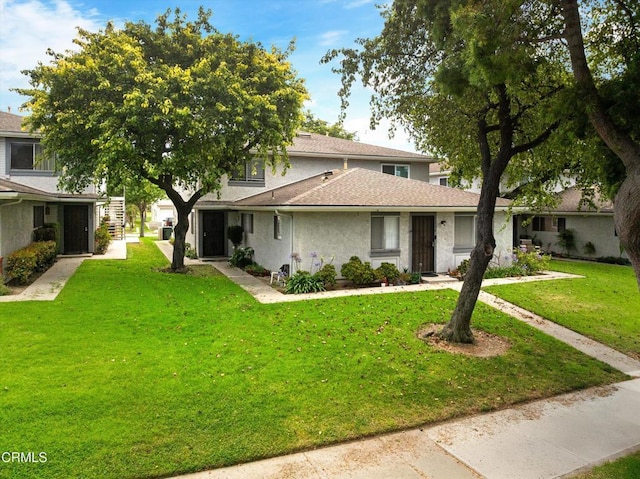 1222 Acadia Pl, Ventura, CA 93003 - view of front of home with a front yard, stucco siding, and a shingled roof