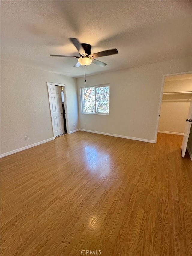 9010 Burke St Unit 22, Pico Rivera, CA 90660 - empty room with a textured ceiling, wood finished floors, and ceiling fan