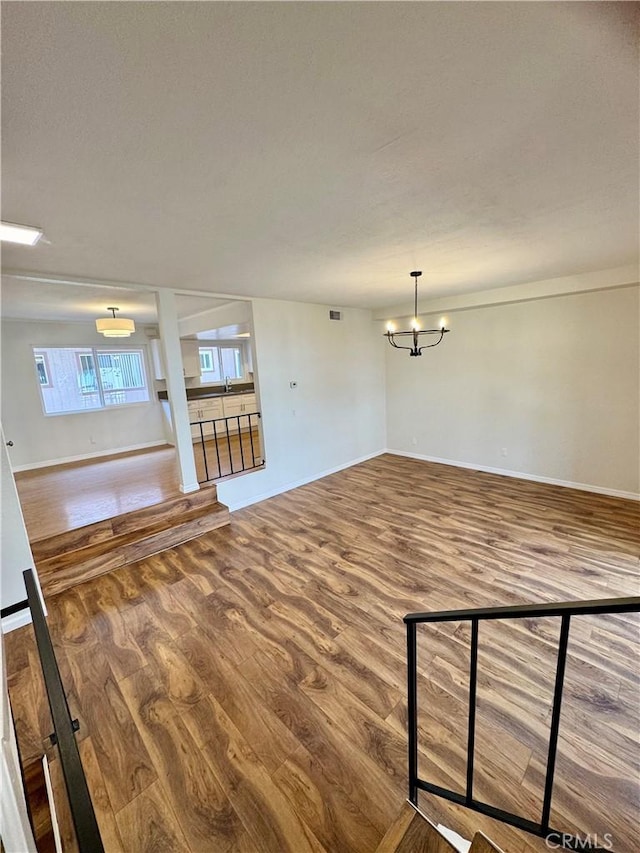 9010 Burke St Unit 22, Pico Rivera, CA 90660 - unfurnished living room featuring a chandelier and wood finished floors
