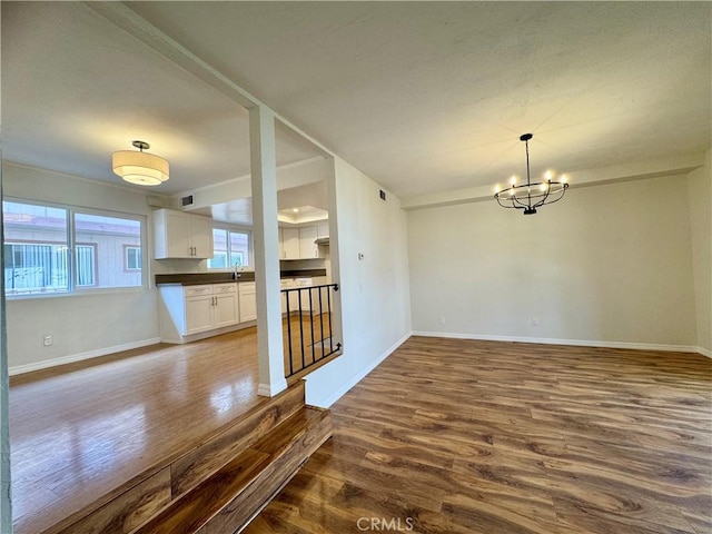 9010 Burke St Unit 22, Pico Rivera, CA 90660 - unfurnished dining area featuring dark wood finished floors and a chandelier