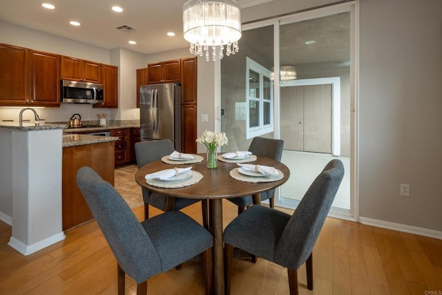 12625 Fiorenza Ln Unit 236, San Diego, CA 92128 - dining area with light wood-style flooring, recessed lighting, and a chandelier
