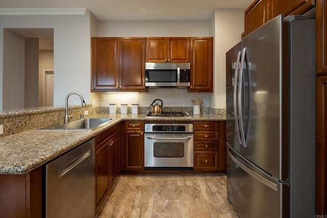 12625 Fiorenza Ln Unit 236, San Diego, CA 92128 - kitchen with appliances with stainless steel finishes, light stone countertops, a peninsula, and crown molding