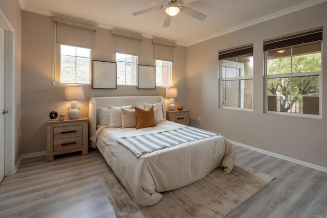 12625 Fiorenza Ln Unit 236, San Diego, CA 92128 - bedroom featuring light wood-type flooring, multiple windows, crown molding, and a ceiling fan