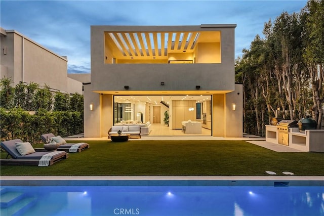 4724 Lemona Ave, Sherman Oaks, CA 91403 - back of house featuring an outdoor kitchen, an outdoor hangout area, a lawn, and an outdoor pool