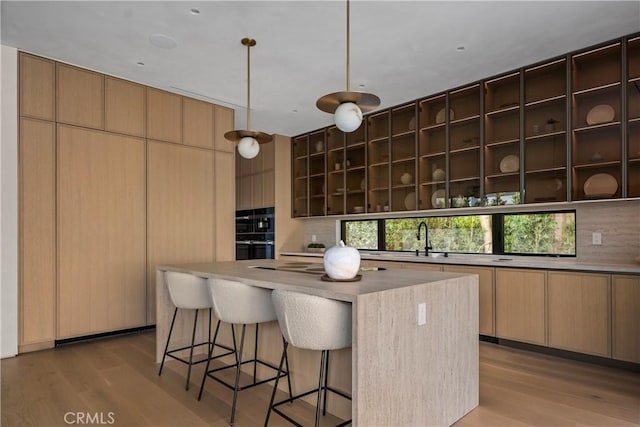 4724 Lemona Ave, Sherman Oaks, CA 91403 - kitchen featuring open shelves, backsplash, light wood-style flooring, and a kitchen island