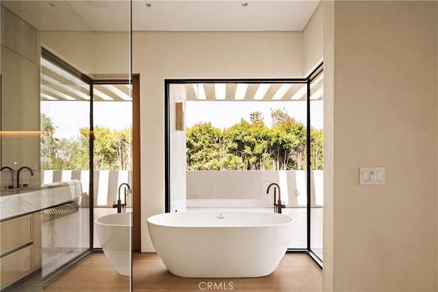 4724 Lemona Ave, Sherman Oaks, CA 91403 - bathroom featuring vanity, a freestanding bath, and wood finished floors