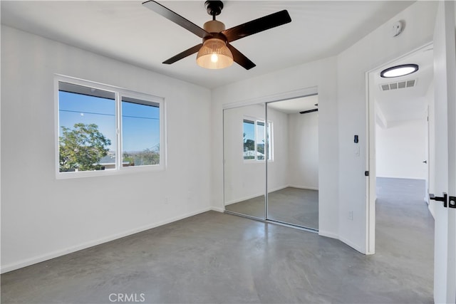 61638 La Jolla Dr, Joshua Tree, CA 92252 - unfurnished bedroom featuring concrete floors, a closet, and a ceiling fan
