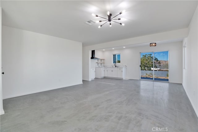 61638 La Jolla Dr, Joshua Tree, CA 92252 - unfurnished living room featuring a chandelier and concrete floors