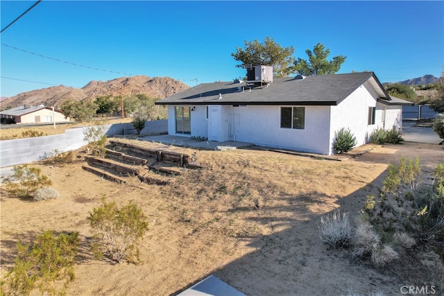 61638 La Jolla Dr, Joshua Tree, CA 92252 - back of property with a mountain view and stucco siding