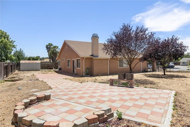 2306 Apion Ct, Paso Robles, CA 93446 - rear view of house with a shed, a fenced backyard, and a patio