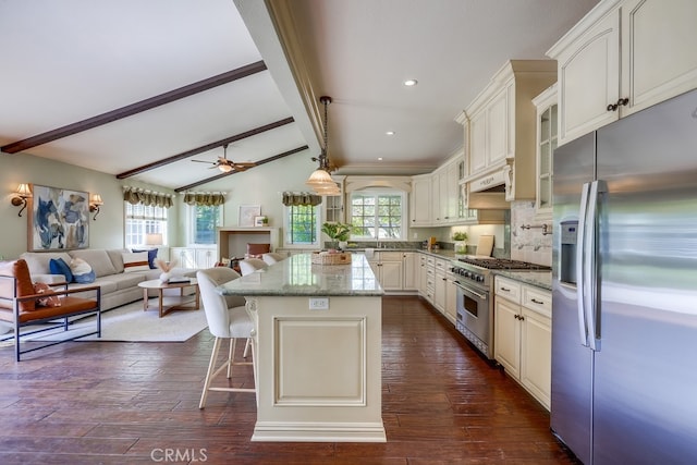 9230 Whitney Way, Cypress, CA 90630 - kitchen featuring appliances with stainless steel finishes, open floor plan, dark wood finished floors, light stone countertops, and a kitchen island